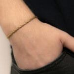 a person wearing a gold bracelet