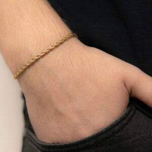 a person wearing a gold bracelet