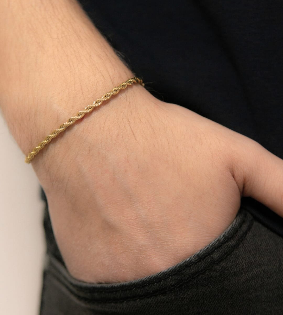 a person wearing a gold bracelet